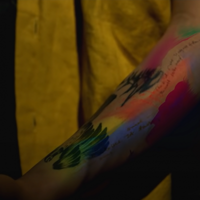 After tattooing himself a bird, colours start spreading on Namjoon in his short film (#5 REFLECTION)