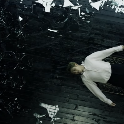 RM surrounded by boken pieces of glass (The WINGS Tour Concert Trailer)