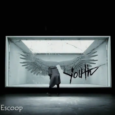 V in front of a pair of wings in a VCR from The WINGS Tour Concert