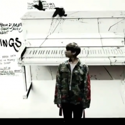 Birds flying over Jungkook in a VCR from the concert