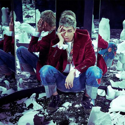 RM surrounded by broken pieces of glass and sculptures during the photo shoot